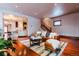 Open living room with hardwood floors, stylish furniture, and seamless flow to the kitchen at 1751 Clermont St, Denver, CO 80220
