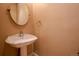 Inviting powder room with a decorative pedestal sink, and wall-mounted mirror creating a stylish and functional space at 1751 Clermont St, Denver, CO 80220