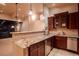 Basement wet bar complete with granite counters, a beverage fridge, dishwasher, and custom cabinetry at 1751 Clermont St, Denver, CO 80220
