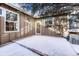 Small backyard with snow, a wooden fence, and a patio at 8621 E Yale Ave # F, Denver, CO 80231