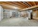 Unfinished basement with water heater and shelving at 8621 E Yale Ave # F, Denver, CO 80231