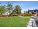 Expansive backyard showcases a lush lawn, mature trees, and a defined patio area, perfect for outdoor living at 4055 S Niagara Way, Denver, CO 80237