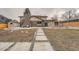 Expansive backyard showcasing a stone pathway, deck, and lush lawn, perfect for outdoor living at 4055 S Niagara Way, Denver, CO 80237