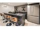 Finished basement includes a bar, sink, seating, and modern refrigerator at 4055 S Niagara Way, Denver, CO 80237