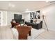 Cozy basement living area featuring a comfortable sofa, accent chairs, and decorative artwork at 4055 S Niagara Way, Denver, CO 80237