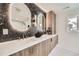Stylish bathroom features a wood vanity, modern lighting, and a stylish mirror at 4055 S Niagara Way, Denver, CO 80237