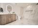 Modern bathroom with wood vanity, quartz countertop, and walk-in shower with niche and marble-like tile surround at 4055 S Niagara Way, Denver, CO 80237
