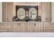 Elegant bathroom vanity with dual sinks, illuminated mirrors, and wood grain cabinets at 4055 S Niagara Way, Denver, CO 80237