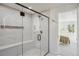 Modern bathroom featuring a glass enclosed shower with white marble tile and bench at 4055 S Niagara Way, Denver, CO 80237