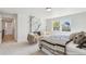 Sunlit bedroom featuring a modern fireplace, soft chairs, and a striped comforter at 4055 S Niagara Way, Denver, CO 80237