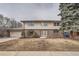 Traditional two-story home with brick and siding, attached two car garage and mature trees at 4055 S Niagara Way, Denver, CO 80237