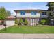 Charming two-story home featuring a well-manicured lawn and inviting front entrance at 4055 S Niagara Way, Denver, CO 80237