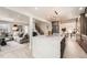 Open-concept kitchen with a view of the living room and stairs, featuring a marble waterfall island at 4055 S Niagara Way, Denver, CO 80237