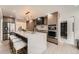Bright kitchen features marble waterfall island, stainless steel appliances, and wood grain cabinets at 4055 S Niagara Way, Denver, CO 80237