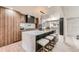 Modern kitchen with a marble countertop island, stainless steel appliances, and custom cabinetry at 4055 S Niagara Way, Denver, CO 80237