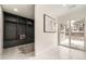 Mudroom with dark storage and seating, leading to the backyard through sliding glass doors at 4055 S Niagara Way, Denver, CO 80237