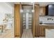Spacious walk-in pantry featuring ample shelving and custom wood cabinetry at 4055 S Niagara Way, Denver, CO 80237