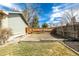 Backyard with garden bed, mature trees, and wood fence at 8025 S Cody St, Littleton, CO 80128