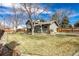 Spacious backyard with mature trees, a wood fence, and pleasant landscaping at 8025 S Cody St, Littleton, CO 80128