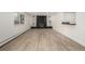 Finished basement with a striking stone fireplace, built-in shelving, and sleek flooring, perfect for relaxing or entertaining at 8025 S Cody St, Littleton, CO 80128