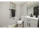 Charming powder room featuring modern fixtures, wallpaper, and a sleek vanity at 8025 S Cody St, Littleton, CO 80128