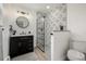 Modern bathroom with tiled shower, contemporary fixtures, and sleek vanity at 8025 S Cody St, Littleton, CO 80128