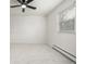 Bedroom with neutral carpet, ceiling fan, and a radiator under a window with blinds at 8025 S Cody St, Littleton, CO 80128