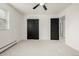 Bright bedroom with neutral carpet, black trim, ceiling fan, and black doors at 8025 S Cody St, Littleton, CO 80128