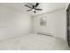 Bright bedroom with neutral carpet, ceiling fan, and a window with blinds at 8025 S Cody St, Littleton, CO 80128