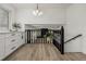 Open hallway with modern lighting and black railing features natural light, connecting living areas seamlessly at 8025 S Cody St, Littleton, CO 80128
