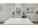 Modern kitchen features white cabinets, stainless steel appliances, quartz countertops, and a window at 8025 S Cody St, Littleton, CO 80128