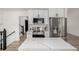 Modern kitchen features white cabinets, stainless steel appliances, quartz countertops, and an island at 8025 S Cody St, Littleton, CO 80128