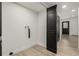 Bright laundry room with wood floor, white walls, and closet space at 8025 S Cody St, Littleton, CO 80128
