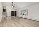 Bright living room with a bay window, ceiling fan, and stairs to the upper level providing a welcoming entrance at 8025 S Cody St, Littleton, CO 80128
