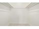 Empty walk-in closet with carpet and metal hanging rods at 8025 S Cody St, Littleton, CO 80128