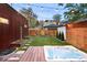 Private backyard with a hot tub, wooden deck, grassy area and landscaping with lighting at 1452 S Washington St, Denver, CO 80210