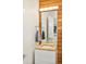 Bathroom featuring a wooden vanity, modern sink, wood paneling, and a decorative mirror at 1452 S Washington St, Denver, CO 80210