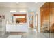 Bright and modern bathroom with double vanity, a wood accent wall, and a glass-enclosed sauna at 1452 S Washington St, Denver, CO 80210