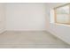 Bright bedroom features large window, concrete floors, and minimal design elements at 1452 S Washington St, Denver, CO 80210