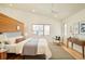 Modern bedroom with wood accent wall, hardwood floors, large windows and a ceiling fan at 1452 S Washington St, Denver, CO 80210