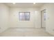 Spacious bedroom features natural light, white walls and concrete flooring, and minimalist design at 1452 S Washington St, Denver, CO 80210