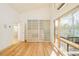 Bedroom with sliding door closet and hardwood floors; lots of natural light from large windows at 1452 S Washington St, Denver, CO 80210