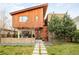 Striking modern home with wood siding, contemporary design, and professionally landscaped front yard at 1452 S Washington St, Denver, CO 80210
