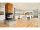 Modern kitchen with a fireplace, dual islands with seating, and light wood floors at 1452 S Washington St, Denver, CO 80210