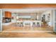 Open kitchen and living space featuring hardwood floors, an island and modern fireplace at 1452 S Washington St, Denver, CO 80210