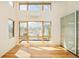 Bright room with hardwood floors, large windows, and a sliding door closet with glass panels at 1452 S Washington St, Denver, CO 80210