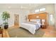 A modern main bedroom featuring wood accent wall, hardwood floors, and large windows at 1452 S Washington St, Denver, CO 80210