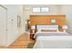 Stylish main bedroom with a wood accent wall, hardwood floors and a side view at 1452 S Washington St, Denver, CO 80210