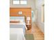 A bright main bedroom featuring a wood accent wall, wooden floors, and large windows at 1452 S Washington St, Denver, CO 80210