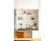 Modern office nook space next to the kitchen featuring ample storage and floating shelves at 1452 S Washington St, Denver, CO 80210
